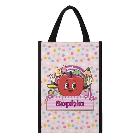 Personalized kids tote bag with name, cute apple and crayon school design, pink polka dot background.