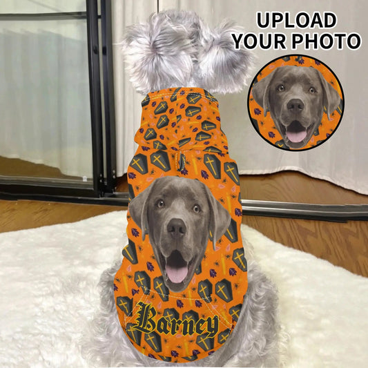 Dog wearing a custom Halloween pet hoodie personalized with photo and name, featuring orange coffin and cross print design.